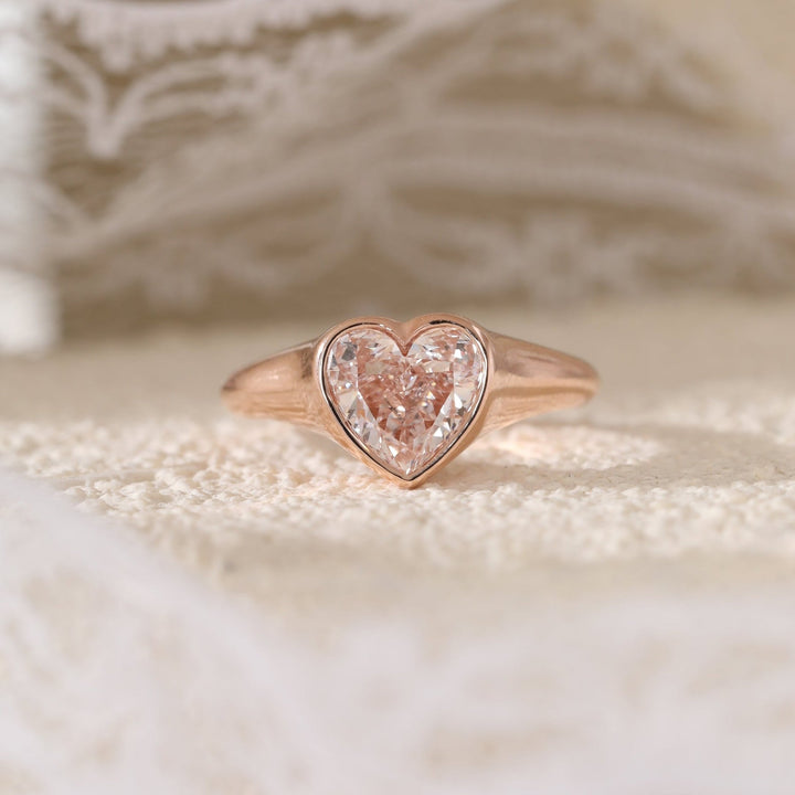 2.5ct Heart Moissanite
Unique Pink Engagement
Bezel Setting Solitaire
Romantic Bridal Jewelry
Pink Gemstone Ring
Heart Shaped Bezel
