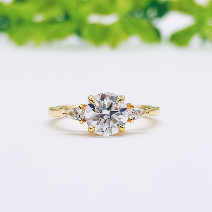 round-cut-three-stone-moissanite-engagement-ring