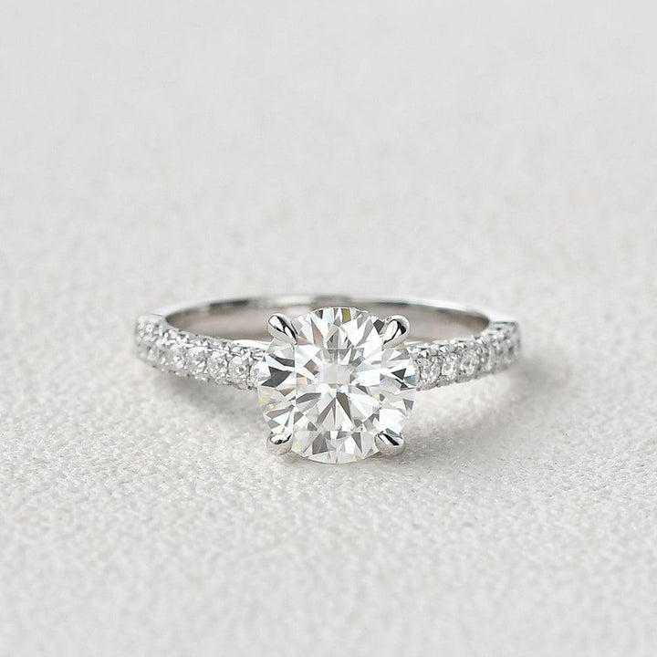 round-cut-solitaire-pave-moissanite-engagement-ring