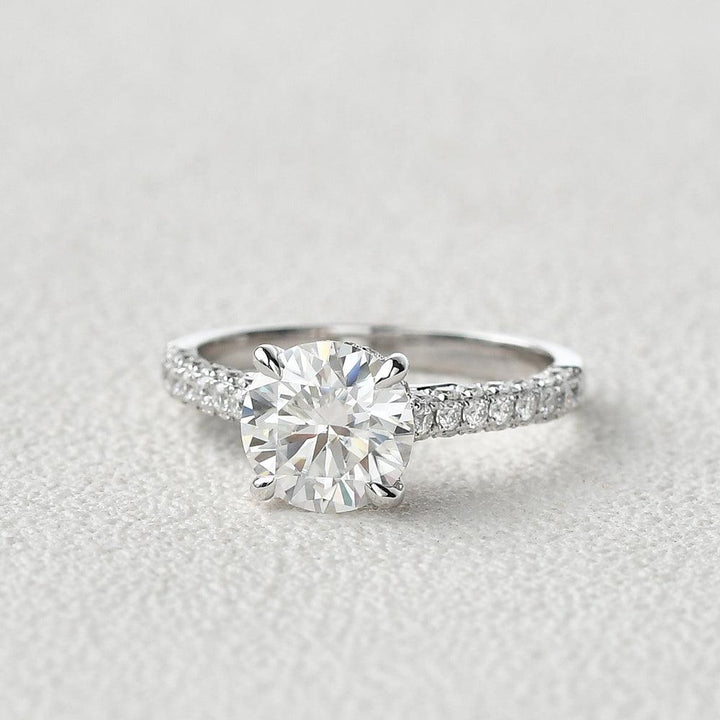 round-cut-solitaire-pave-moissanite-engagement-ring