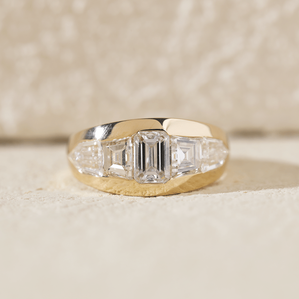 Bezel set engagement ring featuring a tapered side stones in lab grown diamond