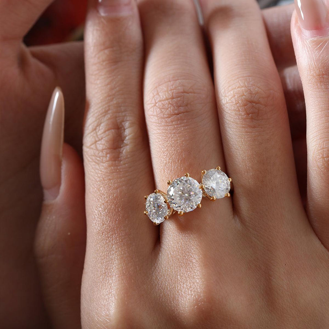 multi-faceted diamond, cathedral setting, side stone engagement ring, unique round diamond, 1.5ct three stone ring, 2ct three stone ring, 2.5ct three stone ring, hand-cut diamond, 