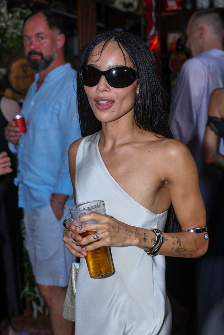 Zoe Kravitz inspired cushion cut engagement ring on finger